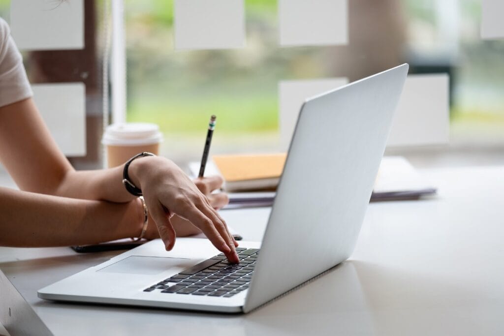 where-to-advertise-dog-walking-online Image of a woman researching online advertising options for her dog walking business.